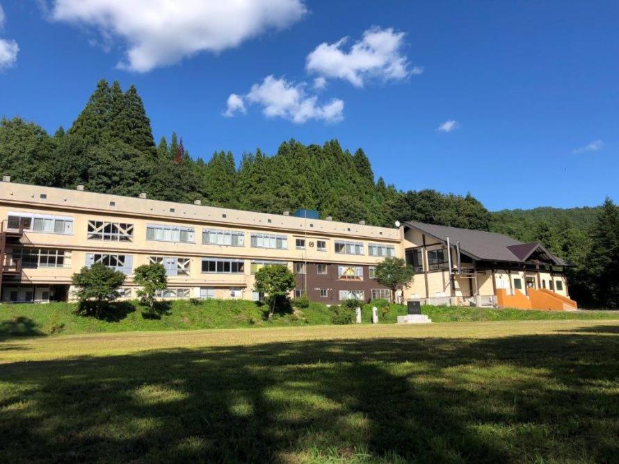 七ヶ宿町にある廃校を活用した宿泊施設「街道HOSTELおたて」の緑豊かな外観